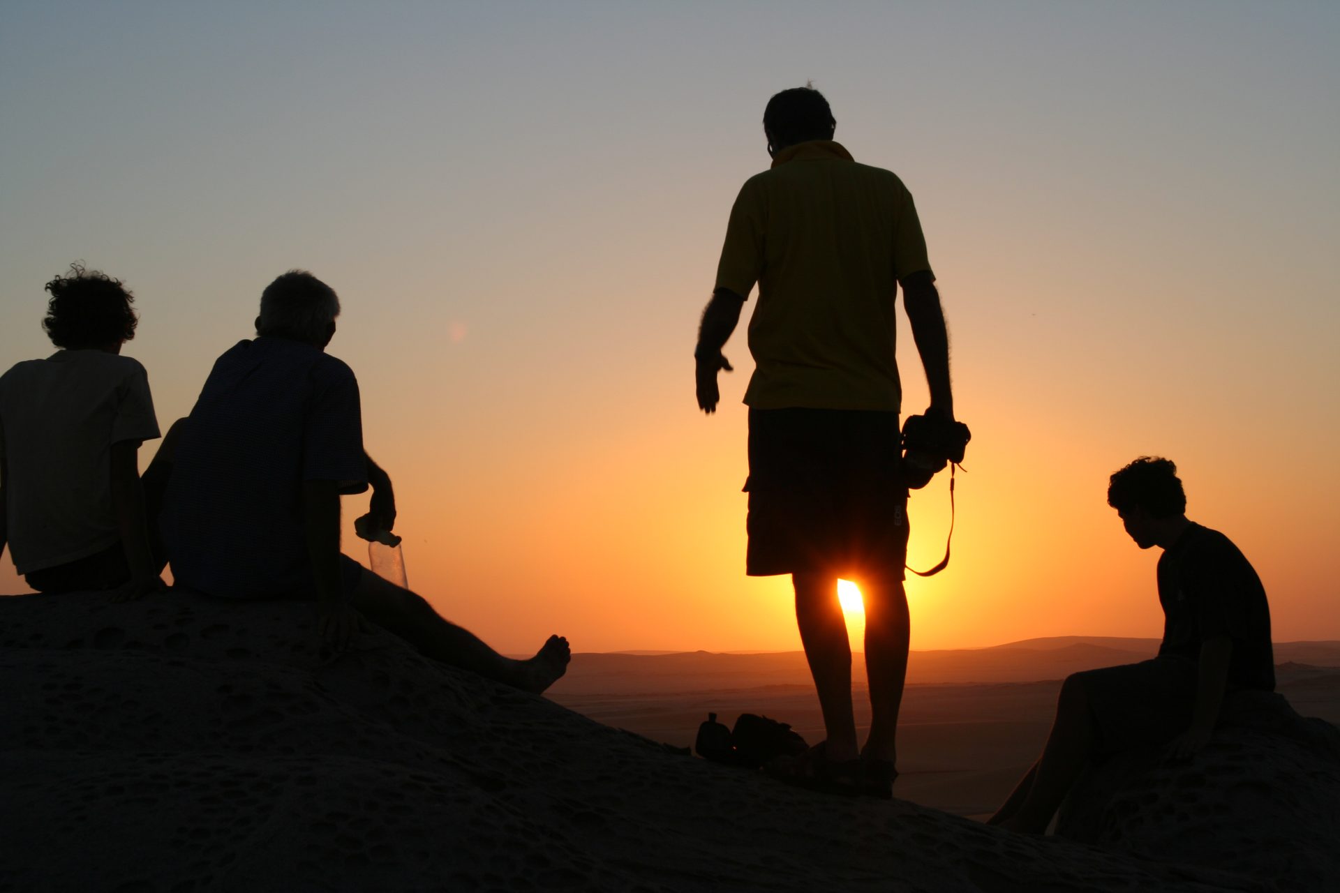 Travellers silhouetted against an African sunset
